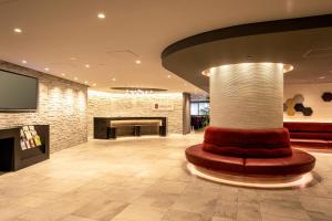 a lobby with a couch and a pillar in a room at Agora Place Osaka Namba in Osaka