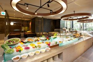 a buffet line with many different types of food at Hotel Agora Osaka Moriguchi in Osaka