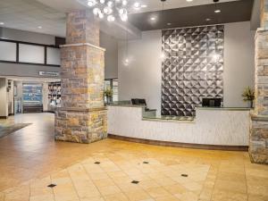 a lobby with a reception desk in a building at Crowne Plaza Milwaukee South by IHG in Milwaukee +78 photos