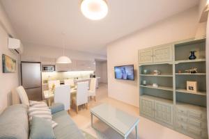 a living room with a couch and a table at Frises Corfu Town Apartment in Ágios Rókkos