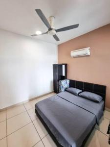 a bedroom with a bed with a ceiling fan at Taiping Centre Point Suite 9 by BWC in Taiping