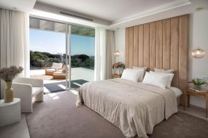 a bedroom with a large bed and a balcony at Villa Alma in Marbella