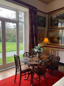 a dining room with a table and chairs and a window at Riverside apartment in Betws-y-coed