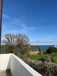 a white wall with a view of the ocean at Villa in Youghal - Carleton Village in Youghal