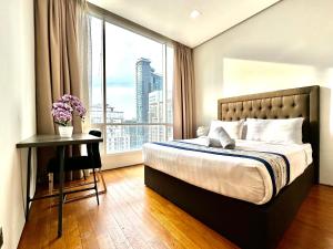 a bedroom with a bed and a large window at Soho Klcc Suites by Liala in Kuala Lumpur