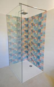 a shower with a glass door in a room at Apartment Leo Blue in Vela Luka +16 photos