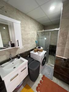 a bathroom with a sink toilet and a shower at Yeni Dairede Manzaralı Lüks Mobilyalı Ferah Daire in Sinop