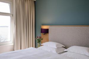 Ein Bett oder Betten in einem Zimmer der Unterkunft Seehotel am Kaiserstrand