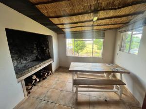 a dining room with a table and a fireplace at Uitzicht Private Nature Reserve and Lodge in Fouriesburg