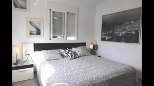 a bedroom with a large bed and a window at FREDOV in Benalmádena