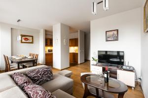 a living room with a couch and a table at Apartamenty Oaza Superior Zakopane in Zakopane