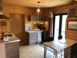 a kitchen with a counter and a table in a room at Chalet Jad'Orres in Les Orres