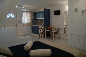 a bedroom with a bed and a kitchen with a table at Christos rooms milos in Adamas