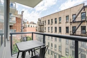 a balcony with a table and chairs on a building at E Village 1BR w WD Elevator Gym NYC-889 in New York