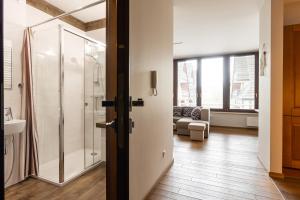 a bathroom with a shower and a glass door at Apartamenty Oaza Superior Zakopane in Zakopane +158 photos
