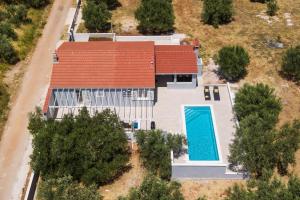 an overhead view of a house with a swimming pool at House Potirna in Blato