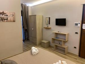 a living room with a tv on a wall at Emyteo Apartment in Tropea