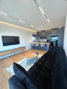 a living room with a couch and a kitchen at panoramic apartment EdenTower in Bat Yam