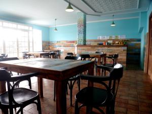 a dining room with wooden tables and chairs at Hotel Langosteira in Finisterre