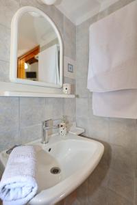 a bathroom with a sink and a mirror at Villa Pefkias in Skopelos Town