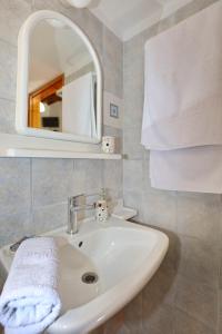 a bathroom with a sink and a mirror at Villa Pefkias in Skopelos Town +17 photos