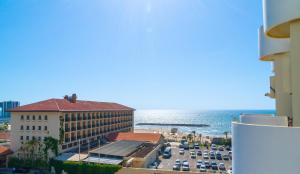 a view of a hotel and a parking lot at Elegant Beachfront Duplex with Private Parking in Herzelia 