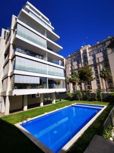 a building with a swimming pool in front of a building at Superior Calpe Pearl Beach in Calpe