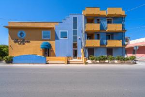 a building on the side of a street at San Martino Apartment Sofia in Cassibile