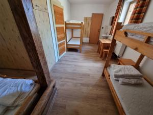 a view of a room with bunk beds and a hallway at Chata Horáreň in Smižany