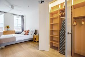 a bedroom with a bed and a closet at Smart SoHo Studio nr the subway NYC-477 in New York