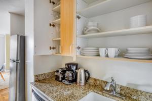 a kitchen with a sink and a counter with dishes at UWS 1BR w Gym Walk to Central Park NYC-165 in New York