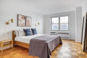 a bedroom with a bed and a window at UWS 1BR w Gym Walk to Central Park NYC-165 in New York