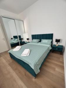 a bedroom with a large bed with two mirrors at panoramic apartment EdenTower in Bat Yam