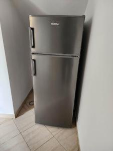 a stainless steel refrigerator in a corner of a room at Villa Ceni 3 in Elbasan