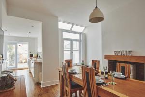 a kitchen and dining room with a table and chairs at Hollie Cottage in Lytham St Annes