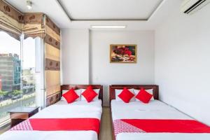 מיטה או מיטות בחדר ב-OYO 265 An Thinh Loc