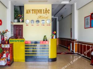 a restaurant with a yellow counter in a building at OYO 265 An Thinh Loc in Danang