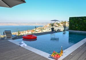a swimming pool with a red object in the water at Villa-SELAVI 3 unit complex with infinity pool in Tiberias