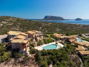 an aerial view of a resort with a swimming pool at Villaggio Sherden - Maison & Relais Apartments in Golfo Aranci