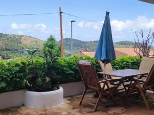 a patio with a table and chairs and an umbrella at Josep in Begur