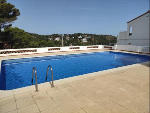 a swimming pool on the side of a building at Josep in Begur