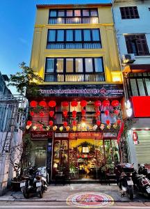a store front of a building with red lanterns at Maison Mackeno in Hanoi