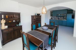 a dining room with a table and blue cabinets at Villa Unica in Biograd na Moru