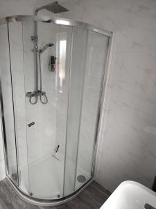 a shower with a glass door in a bathroom at Mallard Court contractor/holiday home in Stamford in Stamford