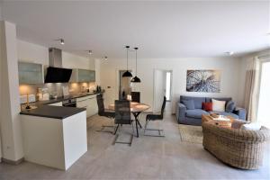 a kitchen and living room with a couch and a table at Compass-App-5 in Hohwacht
