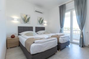 een slaapkamer met twee bedden en een balkon bij Villa Relax with sauna & jacuzzi &gym in Gornji Zemunik +74 foto's