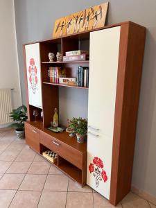 a book shelf in a room with a book shelf at DIP IN SICILY in Lentini
