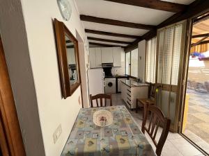 a kitchen and dining room with a table and chairs at Appartamento Nassia 2 By La Via Del Mare Viaggi e Vacanze in Villasimius