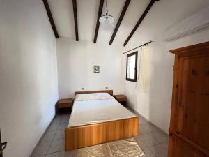 a bedroom with a bed in the corner of a room at Appartamento Nassia 2 By La Via Del Mare Viaggi e Vacanze in Villasimius