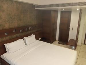 Postel nebo postele na pokoji v ubytování Hotel Kanan